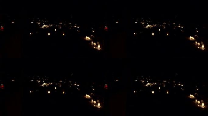 墓碑墓碑坟墓，晚上在墓地燃烧蜡烛。4K