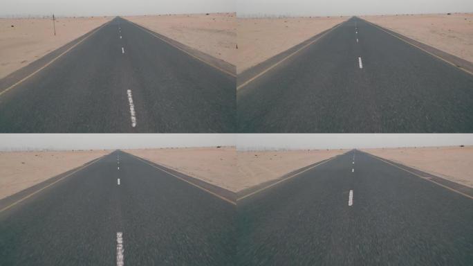 沙尘暴后，金发碧眼的女人穿着黄色正宗背包，在沙质道路上寻找。沙漠中的旅行冒险。