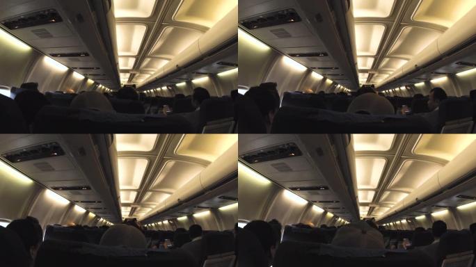 机舱，乘客坐在座位上。