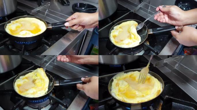 家庭厨房用铁铸盘制作炒鸡蛋的俯视图