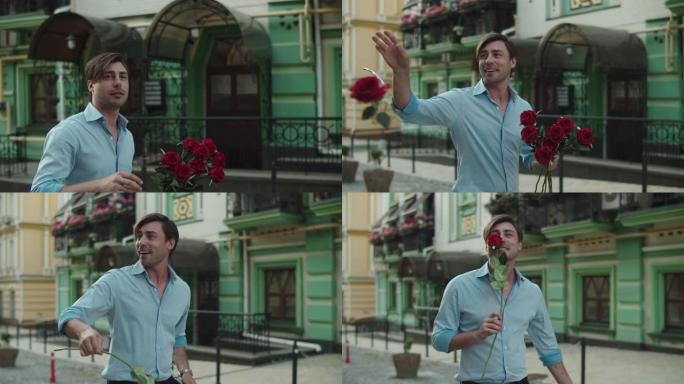 特写男人在铺好的街道上扔红玫瑰。男人在街上闻到玫瑰