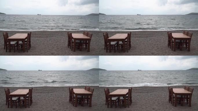 海滩上的空桌子和椅子。