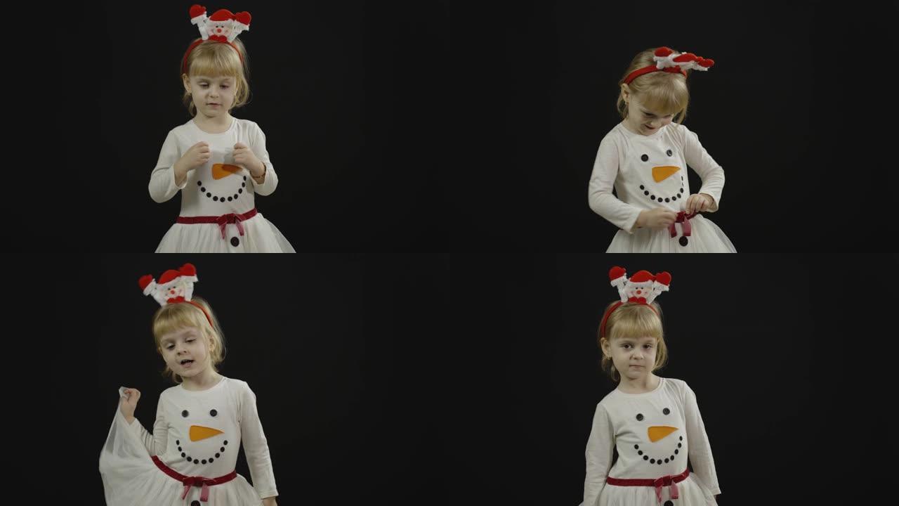 穿着雪人服装的快乐美丽女婴。圣诞节。做鬼脸，跳舞