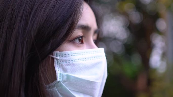 4k年轻可爱的亚洲女性戴着面具看起来思考动作。人类希望灵感动机，医疗保健概念，病毒covid19，模