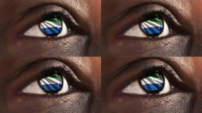 女子黑眼圈在近距离与国旗塞拉利昂在iris与风的运动。视频的概念