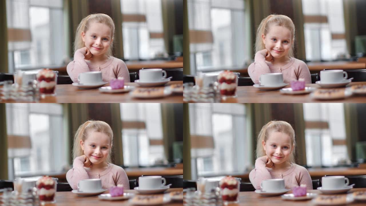 坐在自助餐厅愉快的小孩微笑。用4K红色相机拍摄