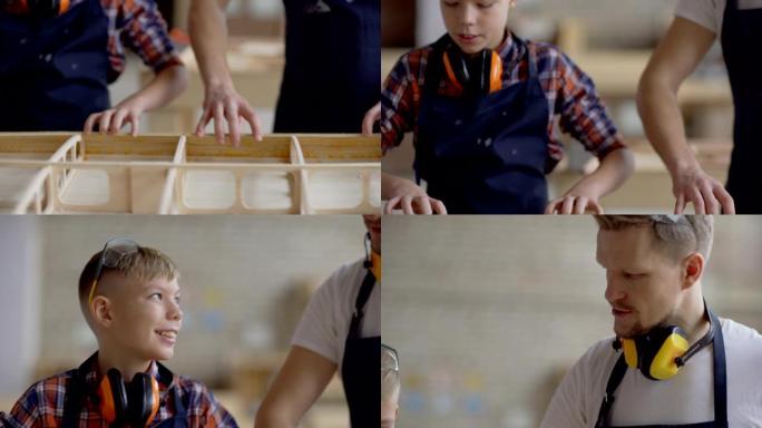 倾斜卡彭特和他的小儿子一起制作木船的跟踪镜头。男子向开朗的好奇男孩解释施工过程
