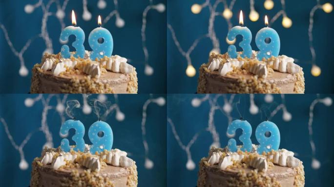 蓝色背景上有39号蜡烛的生日蛋糕。蜡烛吹灭了。慢动作和特写视图
