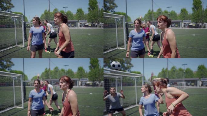 中年妇女在足球场上踢足球