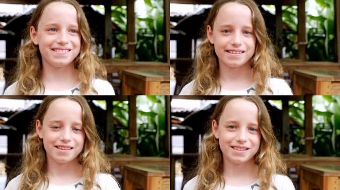 一个10-11岁女孩微笑着看着相机的肖像