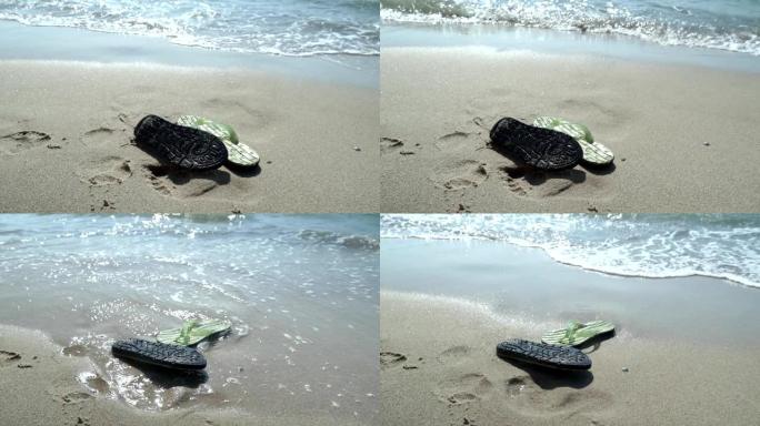 沙滩上的男士拖鞋被水洗了