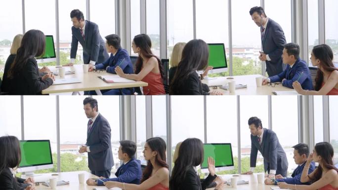 商务团队合作，女企业家在会议室向商务同事发表演讲报告，桌面绿屏