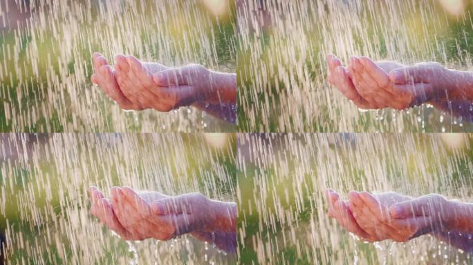 手在倾盆大雨中人物人文雨滴水滴