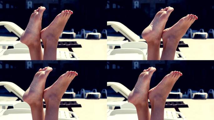 女性挥舞着健康的双腿，在度假胜地的游泳池旁享受