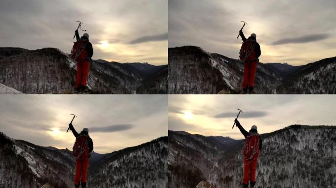 一个年轻的男性登山者站在山顶上，手里拿着一把冰斧的轮廓。