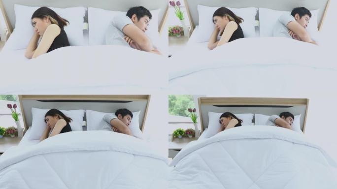 亚洲夫妇在床上有问题，沮丧的夫妇有严重的问题，没有说话感觉被冒犯或固执