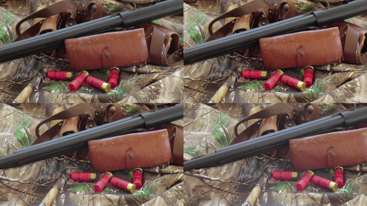 伪装背景上黑色猎枪旧皮革弹壳和红色猎枪弹壳的特写镜头