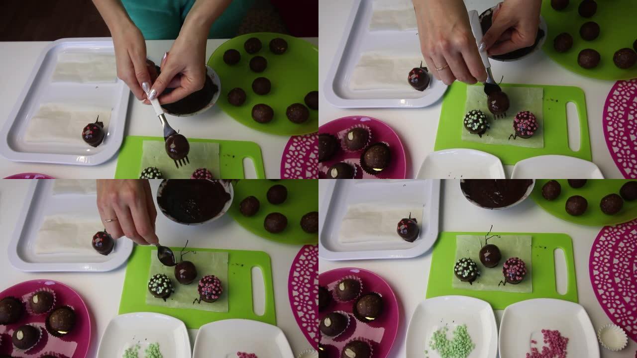 一个女人在表面上放了一个巧克力海绵球。做一个土豆蛋糕。盘子旁边是蛋糕坯料，液体巧克力和彩色洒。