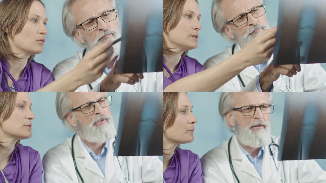 医生和一名护士在医院看x光和ct扫描。中拍，4k慢动作