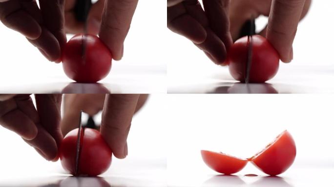 在白色背景上慢动作的番茄切割特写