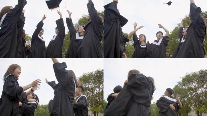 大学校园里拿着毕业证的毕业礼服快乐学生