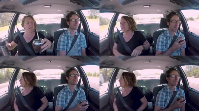 男人和女人在自动驾驶汽车喝酒的伴侣