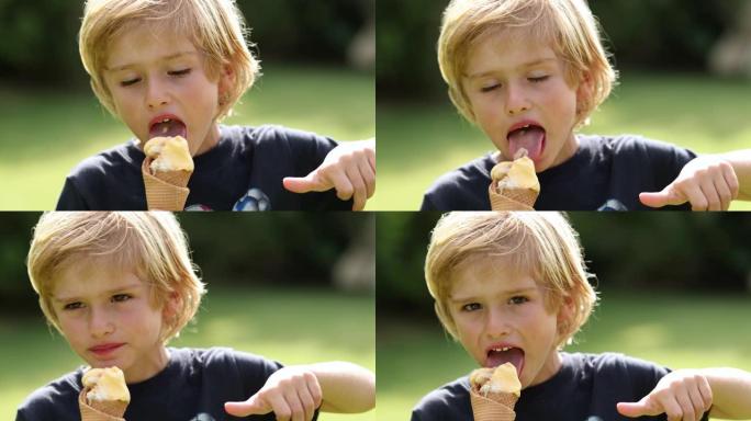 帅气的小男孩孩子在外面吃冰淇淋