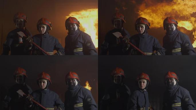 SLO MO消防员，消防战士带着火走向摄像机，在背景中肆虐。