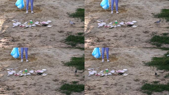 女志愿者帮助清理海滩上的垃圾。很多垃圾躺在沙滩上