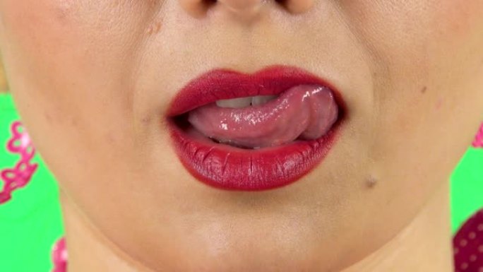 年轻女孩用舌头舔嘴唇。特写