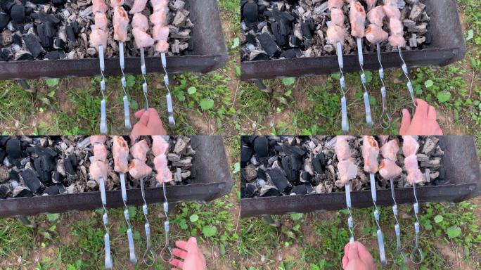 一个在花园，后院的烧烤架上准备烤肉串的人，那里的烟雾和热量