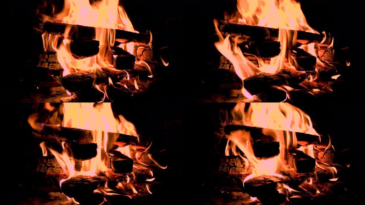 装满木头的热壁炉。燃烧原木产生的真正火焰。壁炉背景。火苗特写。