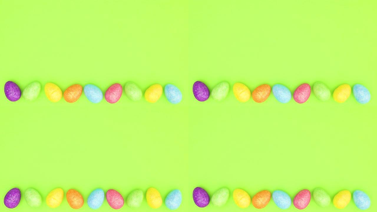 复活节彩蛋在绿色背景的底部左右移动-停止运动