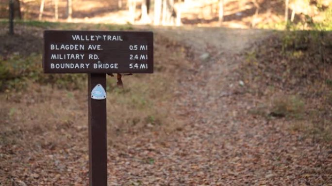 山谷小径的标志，跑步者经过-洛克克里克公园-华盛顿特区-秋天