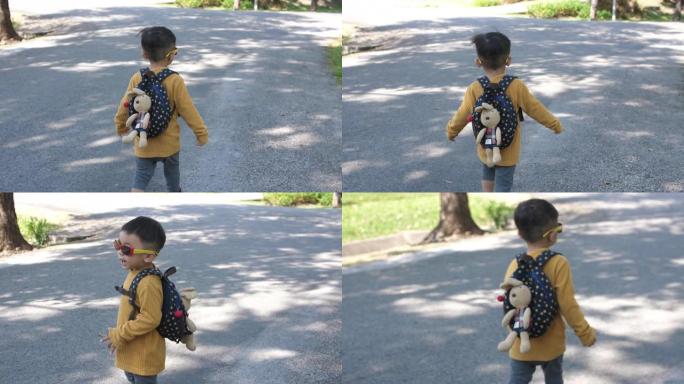 小男孩在公园散步，戴着太阳镜，4K