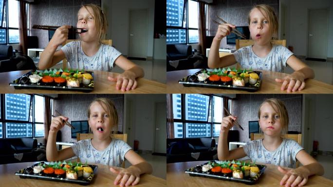 小女孩吃一排包裹的寿司