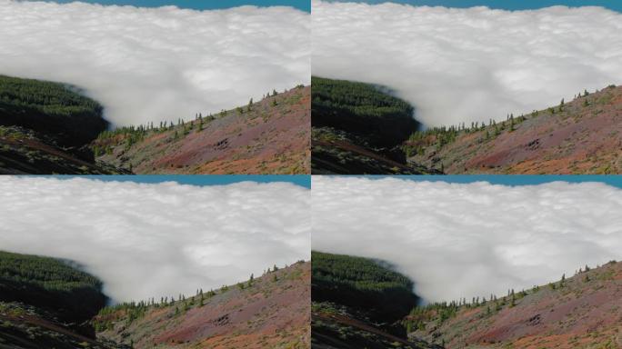 在加那利群岛泰德火山顶部艰难徒步旅行后，云层之上。艰难的一天徒步到火山山顶，从上面看，底部隐藏在云层