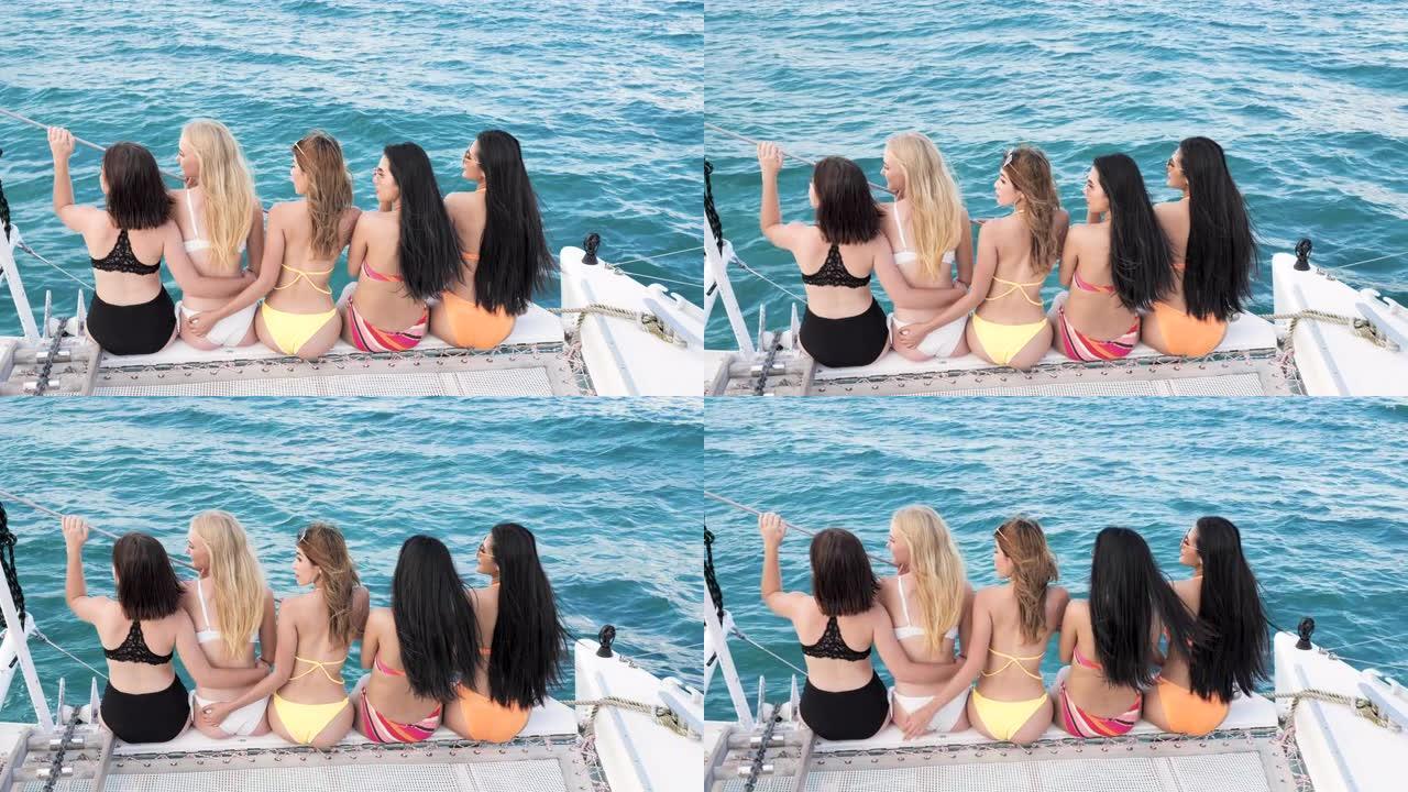 四个漂亮的女孩在游艇上举行派对