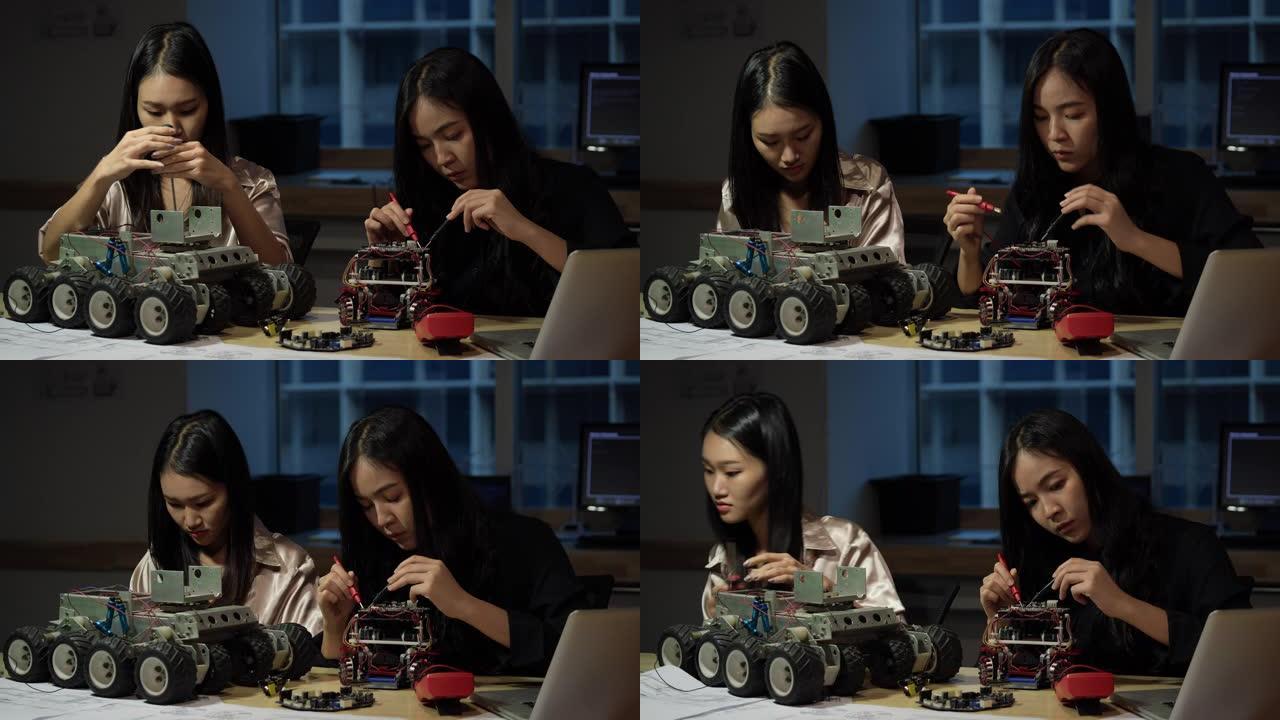 亚洲女工程师在实验室组装和测试机器人手臂反应。建筑师设计电路同步技术和协作开发机器人。