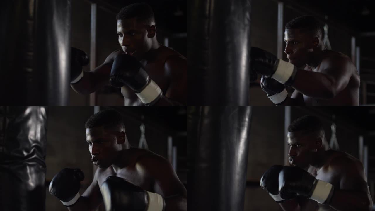 非裔美国拳击手以慢动作击中沉重的包