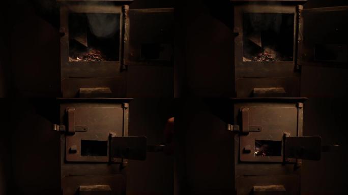 小黑铁炉里燃烧着火。传统阿塞拜疆坚果炉。具有选择性焦点的特写照片