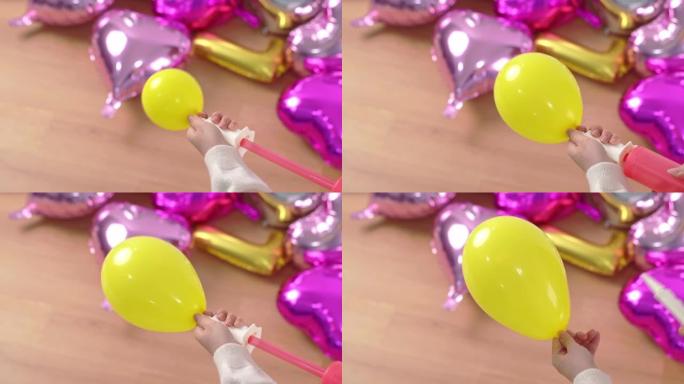女人是手动抽气，将空气放入形状的气球中，用充气机在家准备节日派对装饰，特写，4K，生活方式。