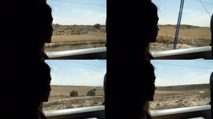 一个迷人女孩的轮廓若有所思地看着火车窗外。4K