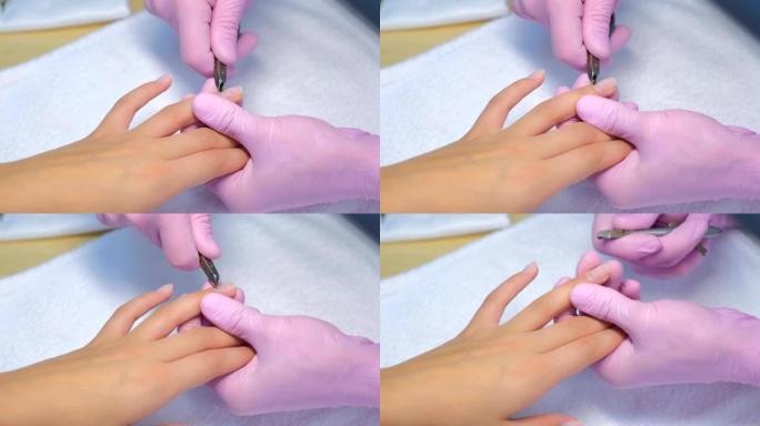 美甲师大师用专业指甲钳制作美甲切割角质层。