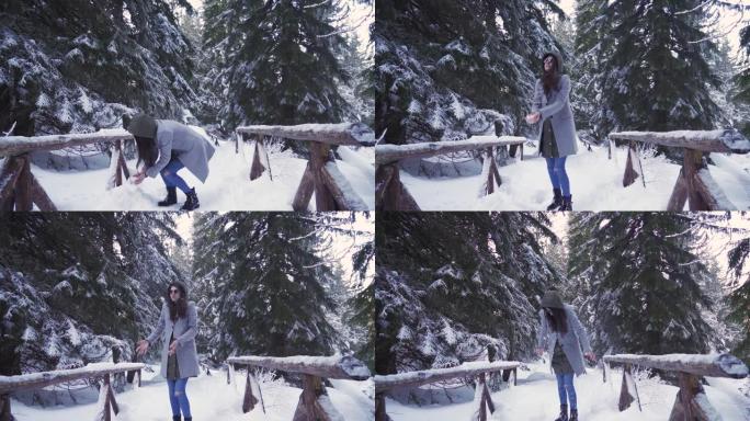 黑发女孩向空中扔少量雪，在下雪天玩得开心