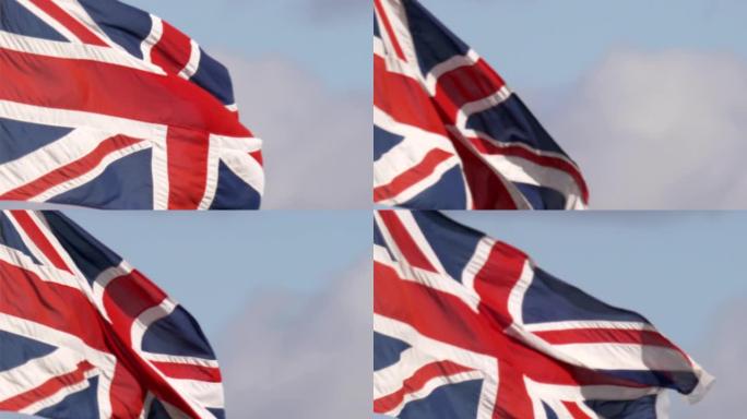 英国国旗旗帜在旗杆上飘扬在蓝天上的特写镜头。