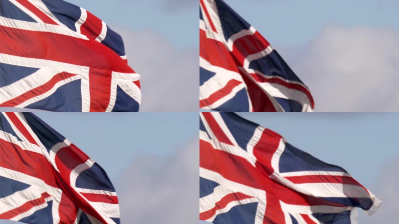英国国旗旗帜在旗杆上飘扬在蓝天上的特写镜头。