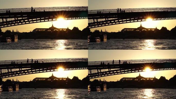 穿过桥拱看到的大皇宫的轮廓。巴黎的日落。