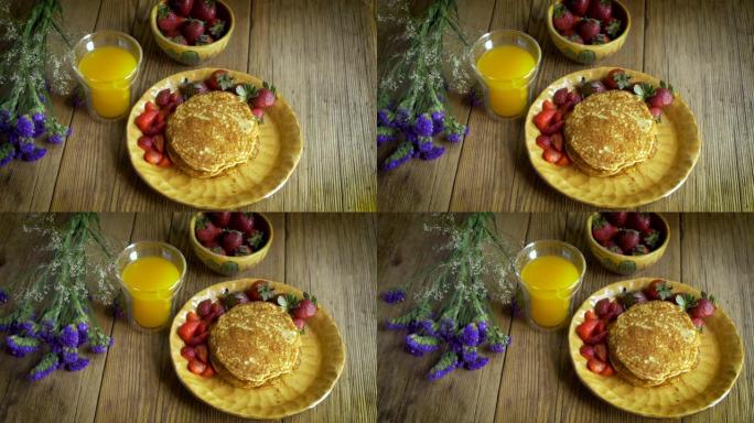 草莓，煎饼和果汁的健康早餐的高角度多莉