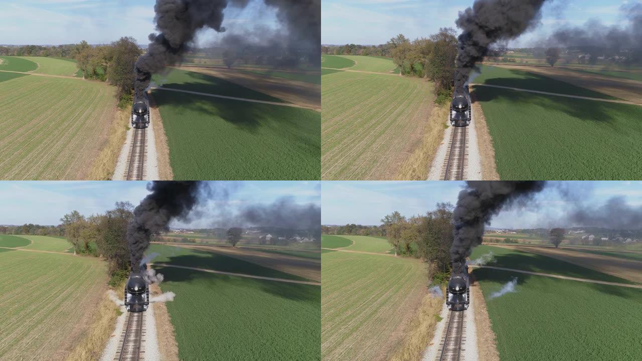 鸟瞰图的古董修复蒸汽机在农田吹黑烟与一个头的观点